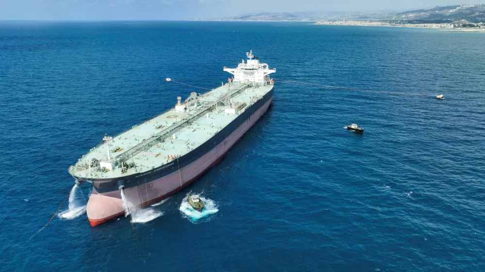 A drone view shows crude oil tanker Nissos Christiana, first ship to transport oil from Syria since the fall of Bashar al-Assad's regime, anchored in the port of Tartus, Syria, September 1, 2025. REUTERS/Mahmoud Hassano
