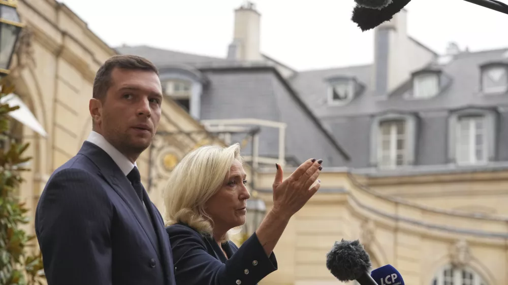 French far right leader Marine Le Pen, right, and Rassemblement National party president Jordan Bardella speak to the media following a meeting with French Prime Minister Francois Bayrou before a confidence vote, at the Hotel Matignon in Paris Tuesday, Sept. 2, 2025. (AP Photo/Thibault Camus)