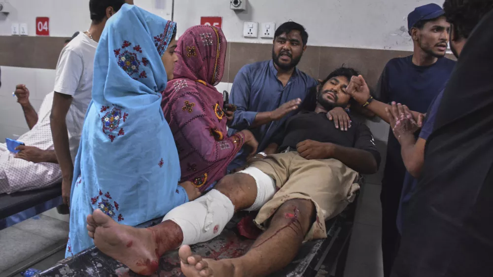 Family members comfort an injured victim of suicide bombing who is receiving treatment at a hospital in Quetta, Pakistan, Tuesday, Sept. 2, 2025. (AP Photo/Arshad Butt)