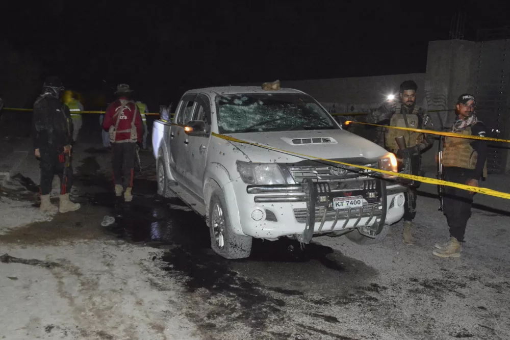 Security officials examine a damaged vehicle at the site of suicide bombing on the outskirts of Quetta, Pakistan, Tuesday, Sept. 2, 2025. (AP Photo/Arshad Butt)