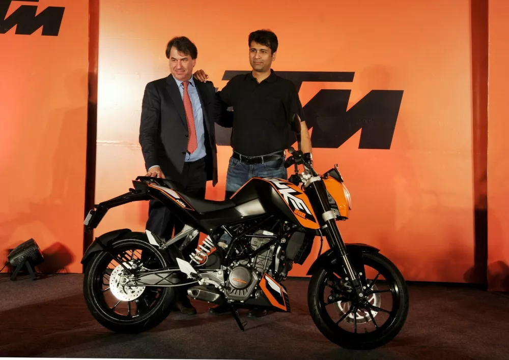 Chief executive officer KTM-sports motorcycles Stefan Pierer (L) along with Managing director Bajaj Auto Rajiv Bajaj poses with the newly launched KTM Duke 200 bike at a function in New Delhi on January 24,2012. Bajaj Auto Limited and KTM sportmotorcycle today launched the much awaited KTM brand in India. The KTM Duke 200 bike is priced 1,17,500 INR (ex-showroom,Delhi).,Image: 115495876, License: Rights-managed, Restrictions:, Model Release: no