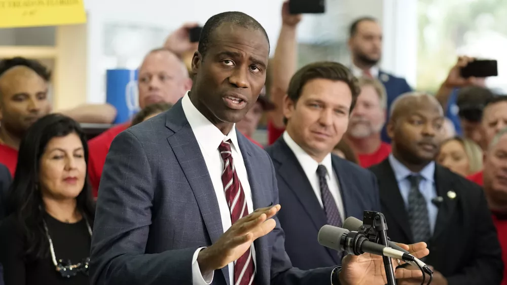 FILE - Florida Surgeon General Dr. Joseph Ladapo gestures as speaks to supporters and members of the media before a bill signing by Gov. Ron DeSantis, Nov. 18, 2021, in Brandon, Fla. (AP Photo/Chris O'Meara, File)