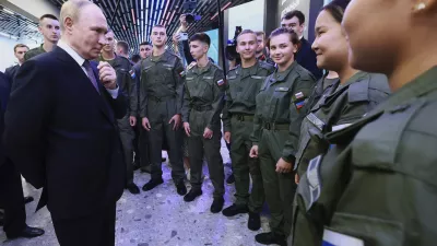 Russian President Vladimir Putin, left, speaks with cadets of the Military-Sports Training and Patriotic Education Center after visiting the interactive exhibition dedicated to the 155th Separate Guards Orders of Suvorov and Zhukov Kursk Marine Brigade named after Hero of Russia Mikhail Gudkov, at the branch of the National Center "Russia" in Vladivostok, Russia, on Thursday, Sept. 4, 2025. (Vladimir Smirnov, Sputnik, Kremlin Pool Photo via AP)