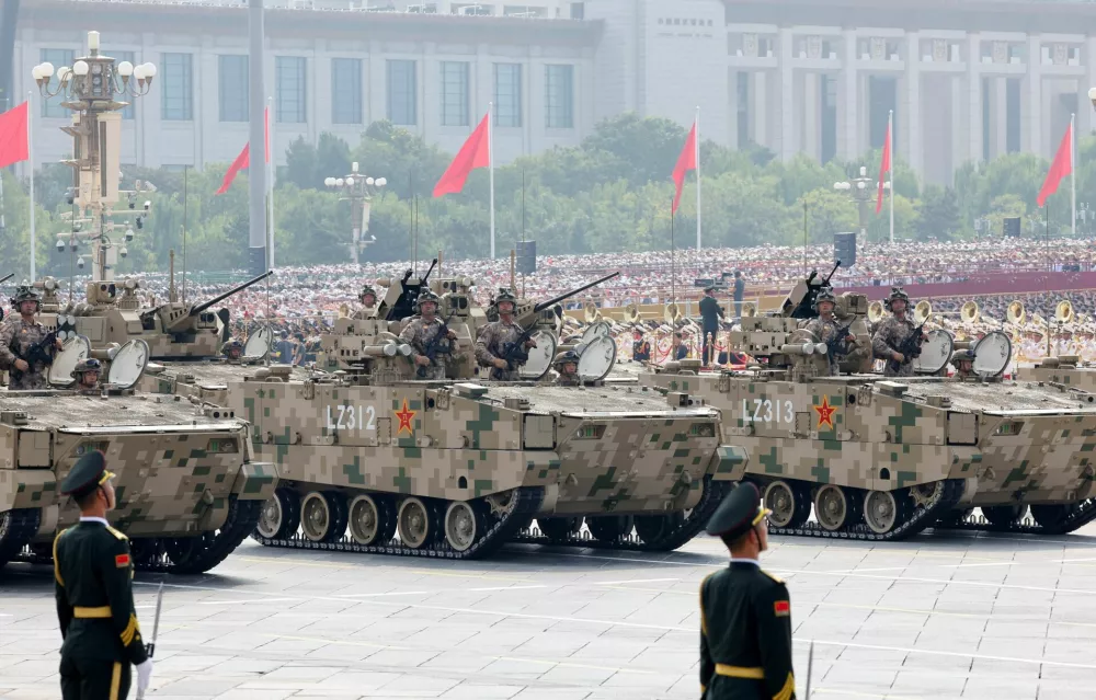 Members of the People's Liberation Army Ground Assault Force stand on armoured vehicles as they take part in a military parade to mark the 80th anniversary of the end of World War Two, in Beijing, China, September 3, 2025. REUTERS/Maxim Shemetov
