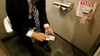 ﻿A man demonstrates a toilet roll for wiping smartphones, installed by Japanese mobile phone company NTT Docomo, in a high-tech bathroom equipped with bidet and heated seat at Narita international airport in Narita, Japan, December 28, 2016. REUTERS/Toru Hanai