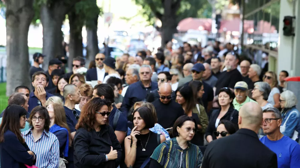 People queue outside the Armani/Teatro to pay tribute as designer Giorgio Armani lies in state, following his death at the age of 91, in Milan, Italy September 6, 2025. REUTERS/Claudia Greco