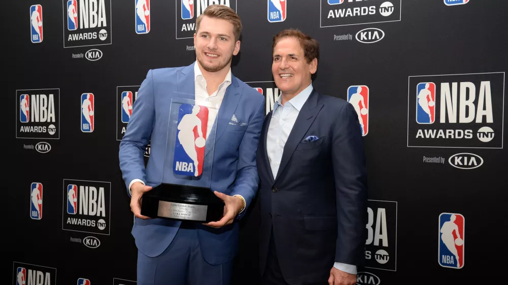 ﻿June 24, 2019; Los Angeles, CA, USA; Dallas Mavericks guard Luka Doncic poses with owner Mark Cuban following his award for Rookie Of The Year at the 2019 NBA Awards show at Barker Hanger. Mandatory Credit: Gary A. Vasquez-USA TODAY Sports - 12952404