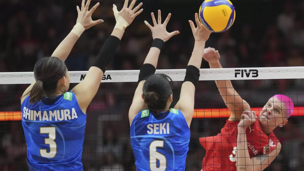 Turkey's Ebrar Karakurt, right, spikes against Japan's Haruyo Shimamura, left, and Nanami Seki during the FIVB Women's Volleyball World Championship 2025 semifinal between Japan and Turkey at the Huamark Indoor Stadium in Bangkok, Thailand, Saturday, Sept. 6, 2025. (AP Photo/Sakchai Lalit)