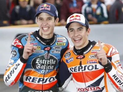 ﻿Moto 3 World Champion Alex Marquez of Spain, left, poses with his brother, Moto GP World Champion Marc Marquez of Spain after the Valencia Motorcycle Grand Prix, the last race of the season, at the Ricardo Tormo circuit in Cheste near Valencia, Spain, Sunday Nov. 9, 2014. (AP Photo/Alberto Saiz)