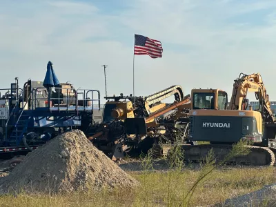 An American flag flies above a piece of heavy machinery at the site of Hyundai Motor Group's electric vehicle plant in Ellabell, Georgia, Friday, Sept. 5, 2025. (AP Photo/Russ Bynum)
