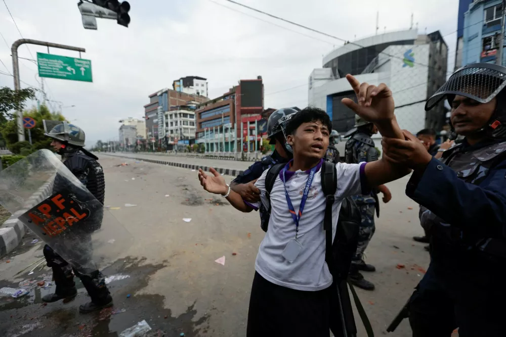 Riot police personnel try to detain a demonstrator during a protest against corruption and the government's decision to block several social media platforms, in Kathmandu, Nepal, September 8, 2025. REUTERS/Navesh Chitrakar