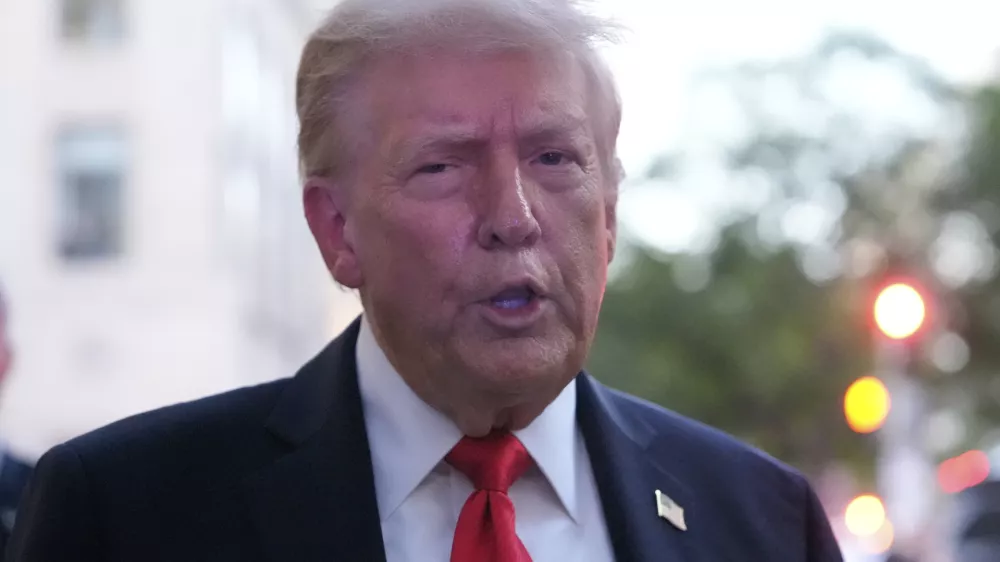 President Donald Trump speaks to reporters before he enters a restaurant near the White House, Tuesday, Sept. 9, 2025, in Washington, to have dinner. (AP Photo/Alex Brandon)