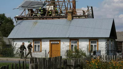 Polish soldiers walk below as firefighters work on the destroyed roof of a house, after Russian drones violated Polish airspace during an attack on Ukraine, with some being shot down by Poland with the backing from its NATO allies, in Wyryki, Lublin Voivodeship, Poland, September 10, 2025. REUTERS/Kacper Pempel