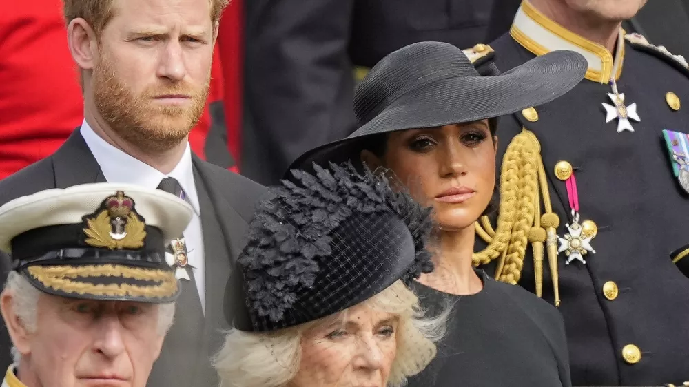 Britain's King Charles III, from bottom left, Camilla, the Queen Consort, Prince Harry and Meghan, Duchess of Sussex watch as the coffin of Queen Elizabeth II is placed into the hearse following the state funeral service in Westminster Abbey in central London Monday Sept. 19, 2022. The Queen, who died aged 96 on Sept. 8, will be buried at Windsor alongside her late husband, Prince Philip, who died last year. (AP Photo/Martin Meissner, Pool)