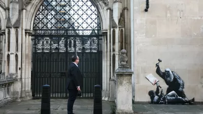 A person looks at a new mural by anonymous artist Banksy on the Royal Courts of Justice in London, Britain, September 9, 2025. REUTERS/Toby Melville