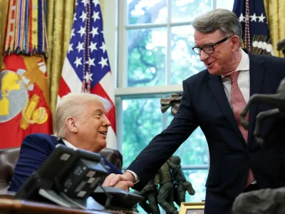 FILE PHOTO: U.S. President Donald Trump shakes hands with Britain's ambassador to the United States, Peter Mandelson after announcing a trade deal with the U.K., in the Oval Office at the White House in Washington, D.C., U.S., May 8, 2025. REUTERS/Leah Millis/File Photo