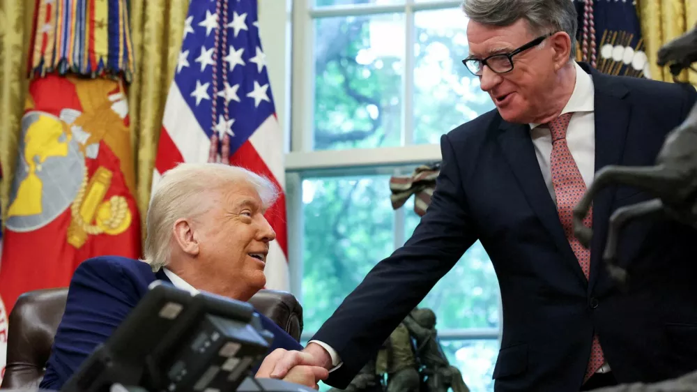 FILE PHOTO: U.S. President Donald Trump shakes hands with Britain's ambassador to the United States, Peter Mandelson after announcing a trade deal with the U.K., in the Oval Office at the White House in Washington, D.C., U.S., May 8, 2025. REUTERS/Leah Millis/File Photo