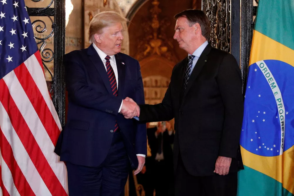 FILE PHOTO: U.S. President Donald Trump shakes hands with Brazilian President Jair Bolsonaro before attending a working dinner at the Mar-a-Lago resort in Palm Beach, Florida, U.S., March 7, 2020. REUTERS/Tom Brenner/File Photo