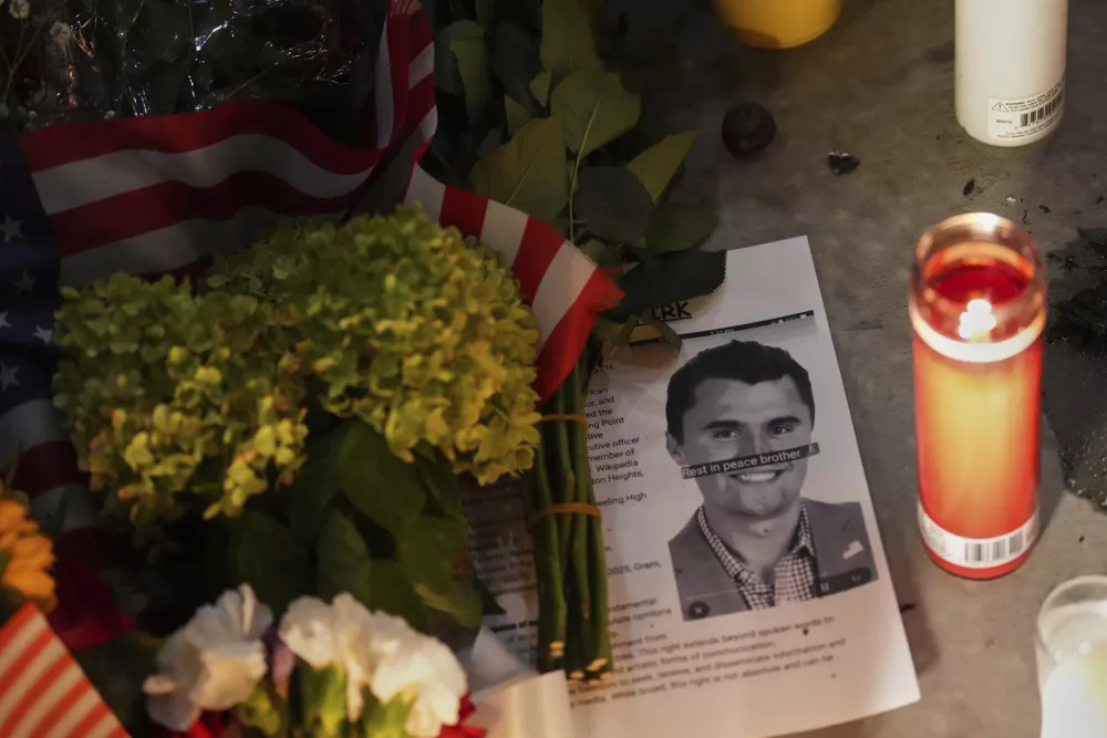 A photo Charlie Kirk, the CEO and co-founder of Turning Point USA who was shot and killed, sits at a vigil in his memory, Thursday, Sept. 11, 2025, in Orem, Utah. (AP Photo/Lindsey Wasson)