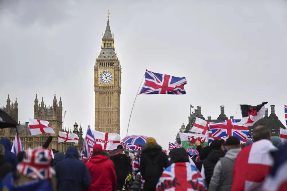 Demonstrators take part in the Tommy Robinson-led Unite the Kingdom march and rally near Westminster, London, Saturday Sept. 13, 2025. (AP Photo/Joanna Chan)