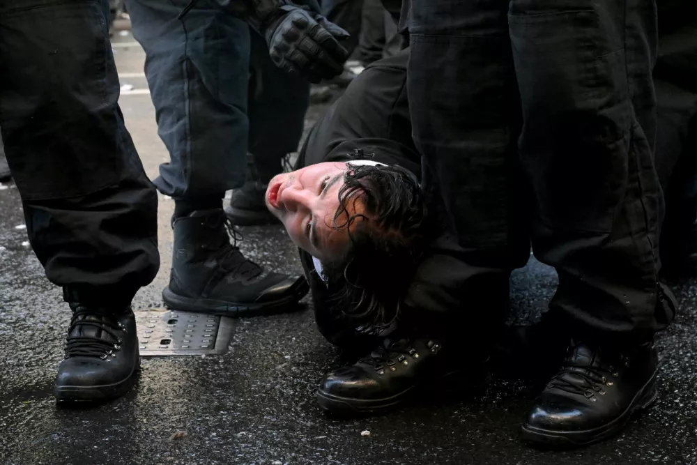 Police officers hold down a supporter of British anti-immigration activist Stephen Yaxley-Lennon, also known as Tommy Robinson, during a demonstration, in London, Britain, September 13,, 2025. REUTERS/Jaimi Joy