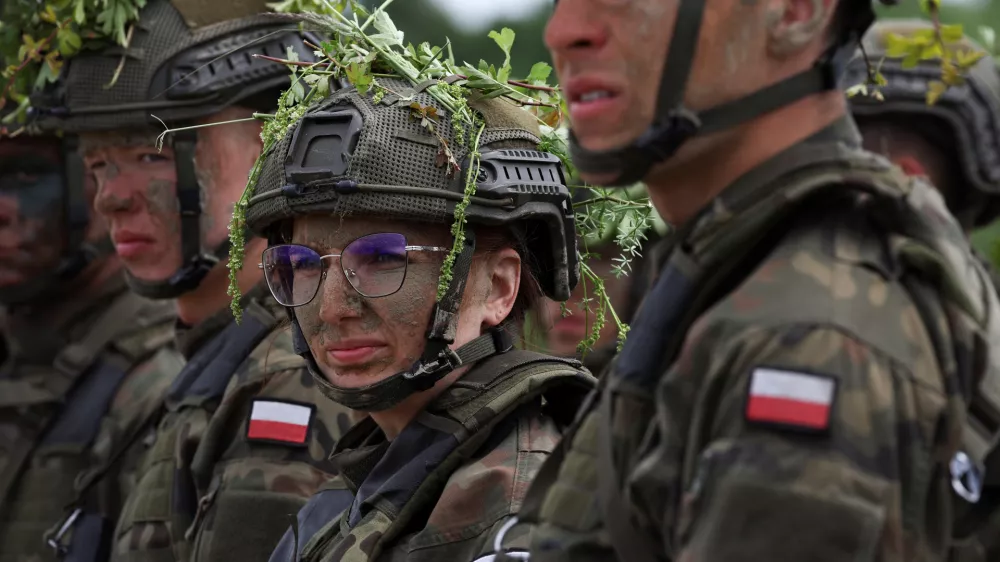 Thirty six-year-old administrator Agnieszka Jedruszak stands with other recruits during voluntary military training at the training ground in Braniewo, Poland, June 24, 2025. REUTERS/Kacper Pempel