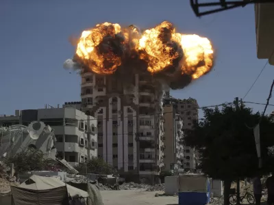 Flames erupt from a building following an Israeli military strike in Gaza City, Sunday, Sept. 14, 2025. (AP Photo/Yousef Al Zanoun)