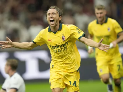 AC Milan's Luka Modric celebrates after scoring his side's opening goal during a Serie A soccer match between AC Milan and Bologna at San Siro stadium in Milan, Italy, Sunday, Sept. 14, 2025. (AP Photo/Luca Bruno)