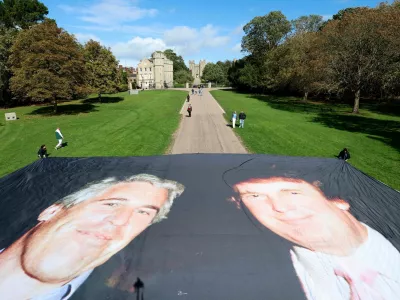 A large banner depicting U.S. President Donald Trump alongside disgraced financier Jeffrey Epstein is displayed near the Windsor Castle by campaign group 'Everyone Hates Elon', protesting Trump's state visit to the country, in Windsor, Britain, September 15, 2025. REUTERS/Hannah McKay REFILE - CORRECTING NAME OF CAMPAIGN GROUP FROM "EVERYBODY HATES ELON" TO "EVERYONE HATES ELON".