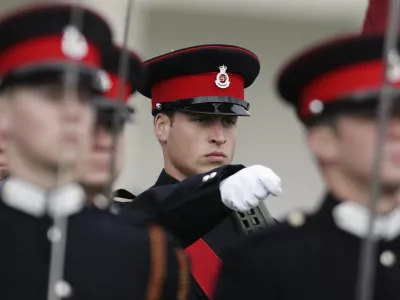 Britain's Prince William (2nd R) marches during the Sovereign's Parade at the Royal Military Academy in Sandhurst, southern England December 15, 2006. Prince William, eager to draw a line under a decade of conspiracy theories about the death of his mother Princess Diana, graduated as an army officer on Friday to launch his military career.   REUTERS/Sang Tan/AP Photo/WPA Pool (BRITAIN)