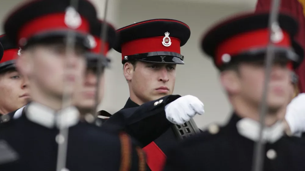 Britain's Prince William (2nd R) marches during the Sovereign's Parade at the Royal Military Academy in Sandhurst, southern England December 15, 2006. Prince William, eager to draw a line under a decade of conspiracy theories about the death of his mother Princess Diana, graduated as an army officer on Friday to launch his military career.   REUTERS/Sang Tan/AP Photo/WPA Pool (BRITAIN)