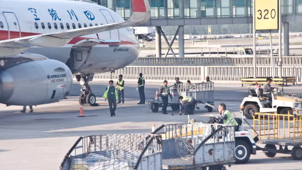 Chinese ground engineering crew prepare a Sichuan Airlines' Airbus A320 neo airplane for take-off on the tarmac of Beijing Capital International Airport (IATA: PEK, ICAO: ZBAA), Chaoyang&acirc;&euro;"Shunyi, China. Sichuan Airlines Co., Ltd. is a Chinese airline based in Chengdu Shuangliu International Airport in Chengdu, Sichuan Province, and is the largest airline in western China
