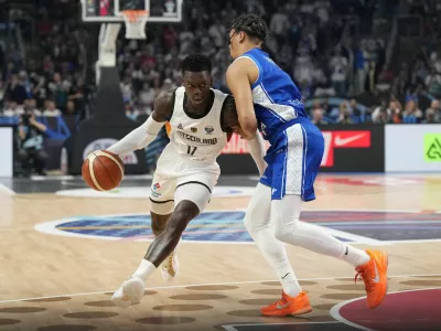 Basketball - FIBA EuroBasket 2025 - Semi Finals - Germany v Finland - Xiaomi Arena, Riga, Latvia - September 12, 2025 Germany's Dennis Schroder in action with Finland's Miro Little REUTERS/Ints Kalnins