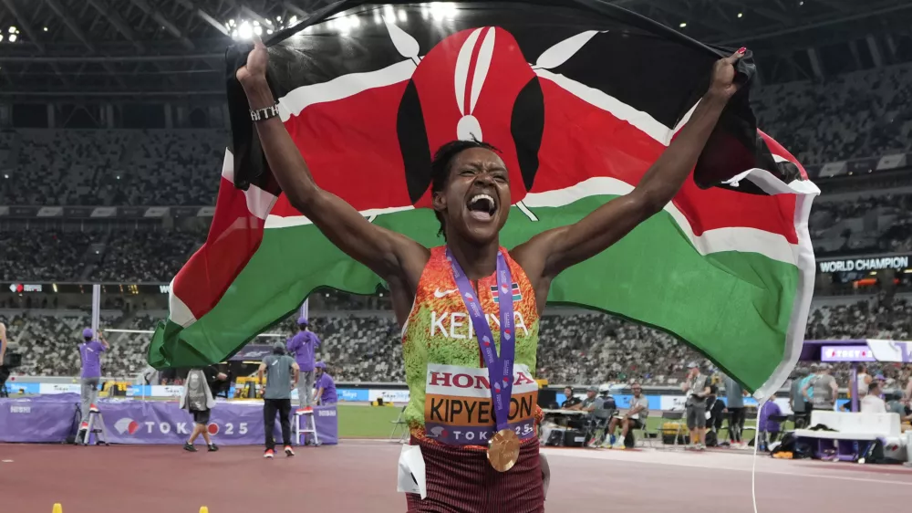 Kenya's Faith Kipyegon celebrates after winning gold medal in the women's 1500 meters final at the World Athletics Championships in Tokyo, Tuesday, Sept. 16, 2025. (AP Photo/Eugene Hoshiko)