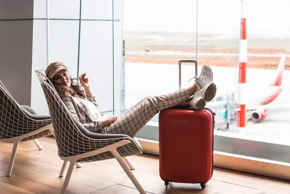 Young beautiful businesswoman with luggage in Airport waiting room.