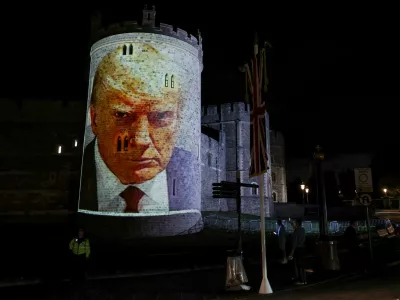 U.S. President Donald Trump's mugshot is projected on Windsor castle, after U.S. President Donald Trump and first lady Melania Trump arrival for a state visit to the country, in Windsor, Berkshire, Britain September 16, 2025. REUTERS/Phil Noble