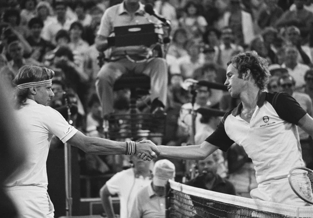 John McEnroe, right, shakes hands after defeating Bj&ouml;rn Borg, left, in the final at the National Tennis Center in New York, Sept. 13, 1981. (AP Photo/Ron Frehm, File)