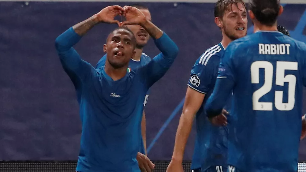 ﻿Soccer Football - Champions League - Group D - Lokomotiv Moscow v Juventus - RZD Arena, Moscow, Russia - November 6, 2019 Juventus' Douglas Costa celebrates scoring their second goal  REUTERS/Maxim Shemetov