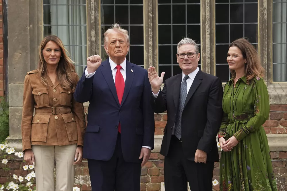 President Donald Trump and Britain's Prime Minister Keir Starmer gesture next to first lady Melania Trump and Victoria Starmer after watching a display by the British Parachute Regiment's "Red Devils" display team at Chequers near Aylesbury, England, Thursday, Sept. 18, 2025. (AP Photo/Evan Vucci)