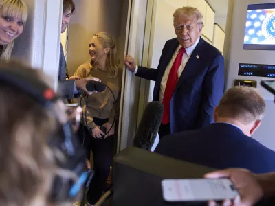 President Donald Trump speaks with reporters after departing the United Kingdom, Thursday, Sept. 18, 2025, aboard Air Force One. (AP Photo/Evan Vucci)