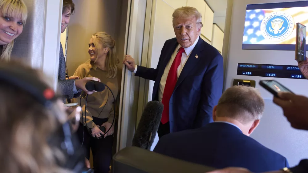 President Donald Trump speaks with reporters after departing the United Kingdom, Thursday, Sept. 18, 2025, aboard Air Force One. (AP Photo/Evan Vucci)