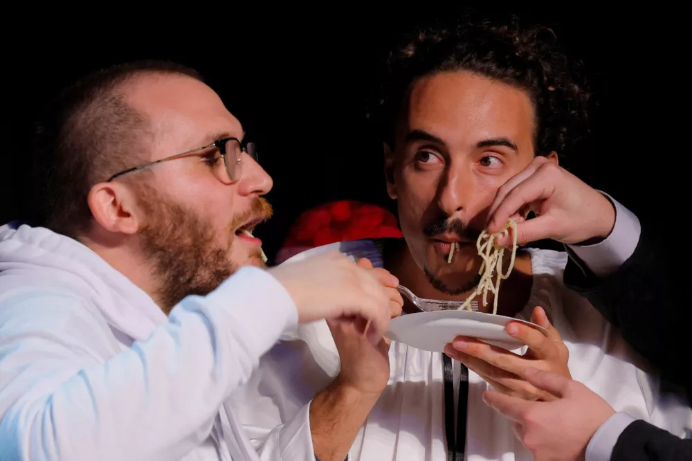 Researchers eat pasta as they accept the Physics Prize for their study "Phase Behavior of Cacio and Pepe Sauce" during the 35th First Annual Ig Nobel Prize ceremony, in Boston, Massachusetts, U.S., September 18, 2025. REUTERS/Brian Snyder
