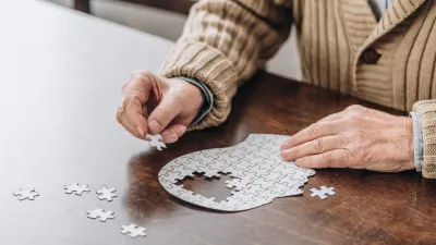 cropped view of senior man playing with puzzles