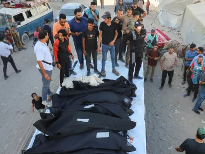 Mourners gather for a funeral around body bags containing the remains of the Dugmosh family, who were killed in an Israeli strike on a house on Saturday amid their military operation, according to medics, at Al-Shifa Hospital in Gaza City, September 21, 2025. REUTERS/Ebrahim Hajjaj