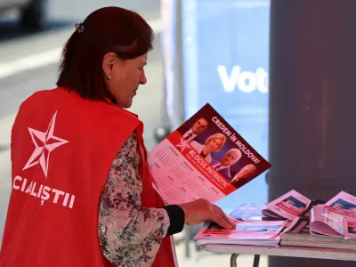 A participant of the Patriotic Electoral Bloc's campaign sorts leaflets while agitating voters in a street ahead of Moldova's upcoming parliamentary elections in Chisinau, Moldova, September 21, 2025. REUTERS/Vladislav Culiomza