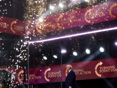 President Donald Trump walks on stage to speak at a memorial for conservative activist Charlie Kirk, Sunday, Sept. 21, 2025, at State Farm Stadium in Glendale, Ariz. (AP Photo/Julia Demaree Nikhinson)