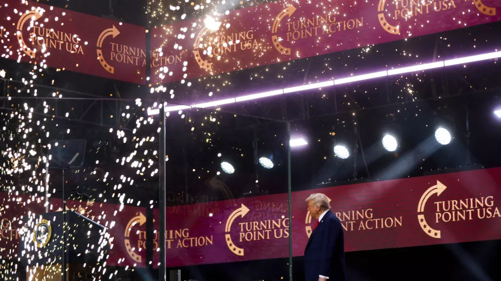President Donald Trump walks on stage to speak at a memorial for conservative activist Charlie Kirk, Sunday, Sept. 21, 2025, at State Farm Stadium in Glendale, Ariz. (AP Photo/Julia Demaree Nikhinson)