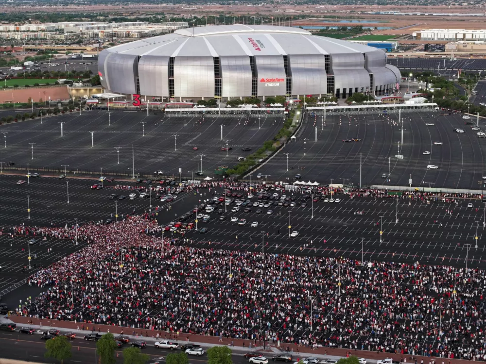 Drone view shows people arriving to attend a memorial service for slain conservative commentator Charlie Kirk at State Farm Stadium, in Glendale, Arizona, U.S., September 21, 2025. REUTERS/Cheney Orr