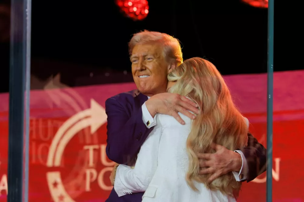 U.S. President Donald Trump embraces Erika Kirk, the wife of slain conservative commentator Charlie Kirk and new CEO of Turning Point USA, during a memorial service at State Farm Stadium in Glendale, Arizona, U.S., September 21, 2025. REUTERS/Brian Snyder