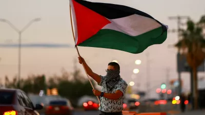 A man holds a Palestinian flag as he attends a demonstration in support of Palestinians and the Global Sumud Flotilla, amid the ongoing conflict in Gaza, outside the U.S. Consulate in Ciudad Juarez, Mexico, September 20, 2025. REUTERS/Jose Luis Gonzalez